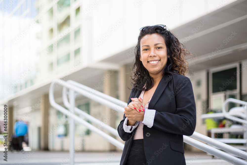 Young Latin American business woman with confident gesture. She is outdoors and wearing elegant clothes. Space for text. Young Latin American business woman with confident gesture. She is outdoors and wearing elegant clothes. Space for text.