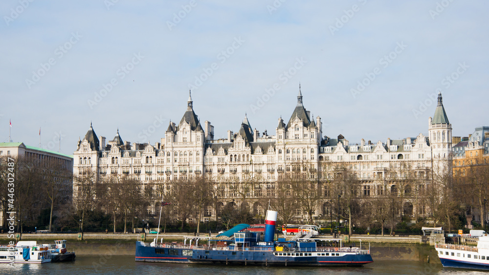  Whitehall Court seen from South Bank of London. Blue sky, some ships on the river. London, UK, Europe