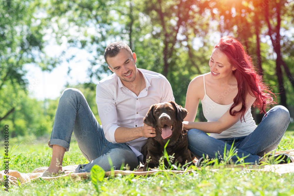 Couple with a dog in the park Couple with a dog in the park