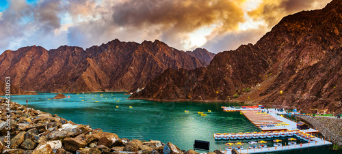 Beautiful view of Hatta Dam or Lake and Hajar Mountain in the Emirate of Dubai, UAE at sunset