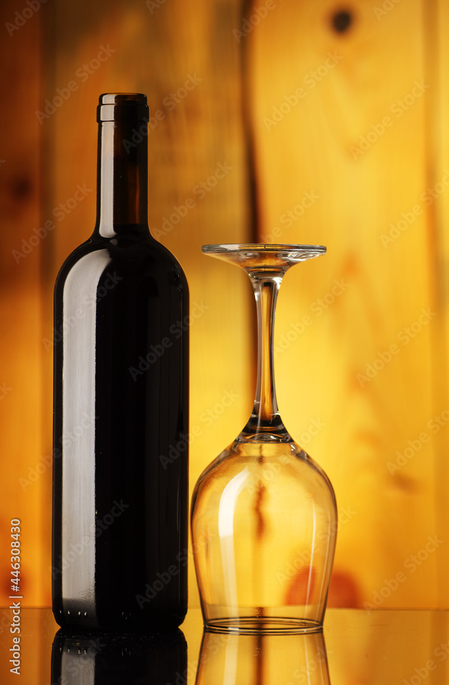 bottle with wine and an inverted glass