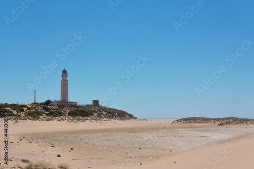 Beach landscape with lighthouse in the background. © Rodrigo