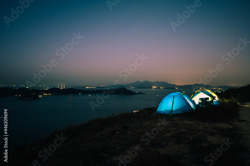 Tourist camping tent on top of mountain with sea and sky background, at Yuk Kwai Shan (Mount Johnson) located in Ap Lei Chau,Hong Kong.Traveling and camping concept