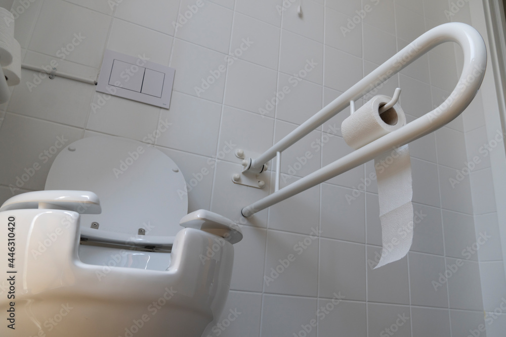 Bathroom equipped with toilet for the elderly and disabled people with fall prevention handle ...