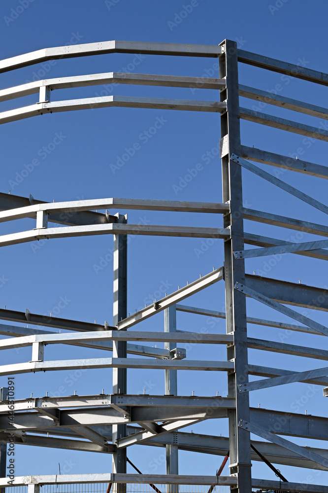 Steel construction frame of a new multi storey commercial building against a blue sky. No people. Steel construction frame of a new multi storey commercial building against a blue sky. No people.