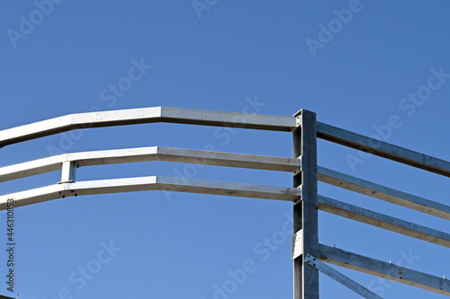 Steel construction frame of a new multi storey commercial building against a blue sky. No people.