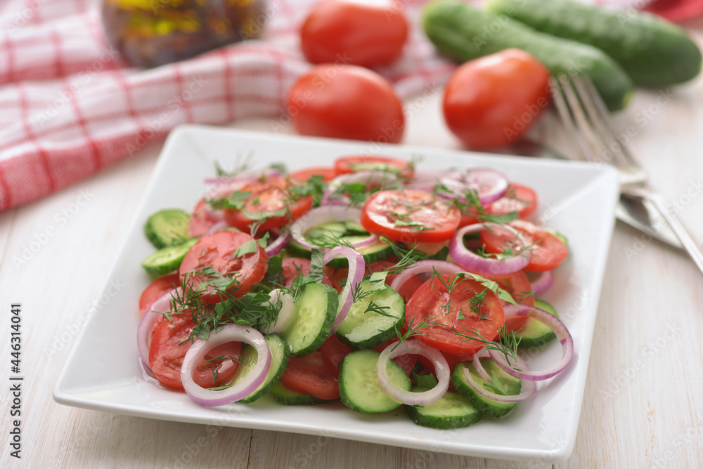 Fresh vegetable salad with cucumber, tomato and red onion