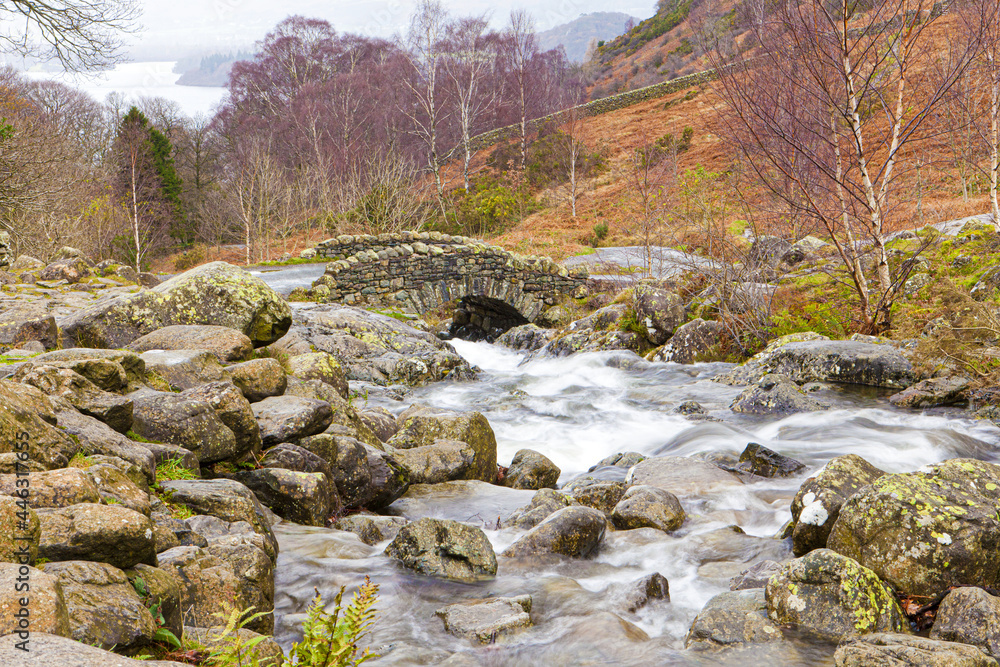 A wet autumn day in the English Lake District - Barrow Beck flowing under Ashness Bridge, Cumbria UK with Derwentwater in the background A wet autumn day in the English Lake District - Barrow Beck flowing under Ashness Bridge, Cumbria UK with Derwentwater in the background