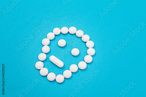 Dangerous Pharmaceutical Products or Unsafe Pills and Tablets - Skull or Death Symbol Made from White Pills Lying on Blue Background