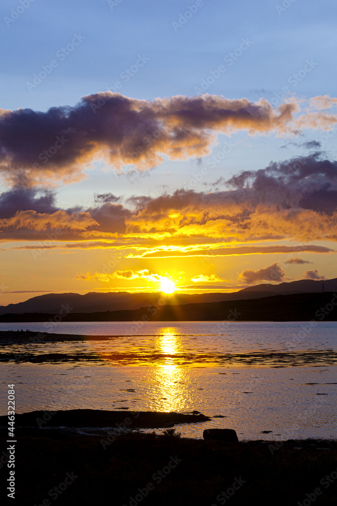 A sunset across Loch na Cille to the Keillmore Peninsula viewed from Danna, Knapdale, Argyll & Bute, Scotland UK