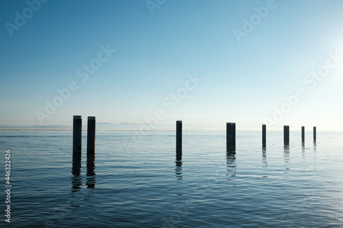 Serene scene of pier remnants at sunset at Garry Point Park in Steveston, British Columbia.