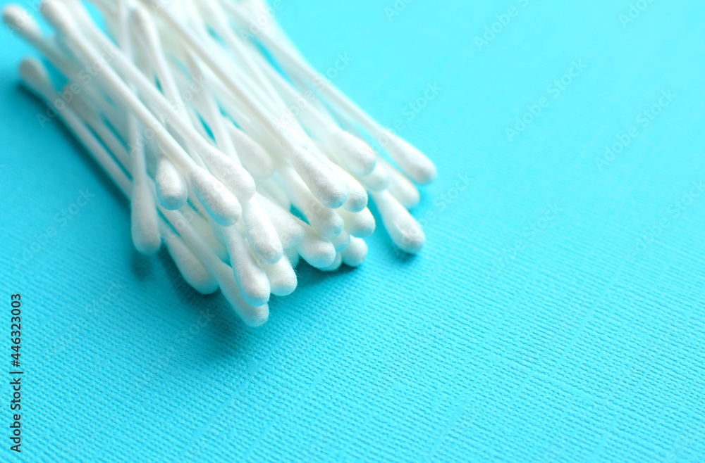Lots of plastic cotton swabs on a blue background. Lots of plastic cotton swabs on a blue background.