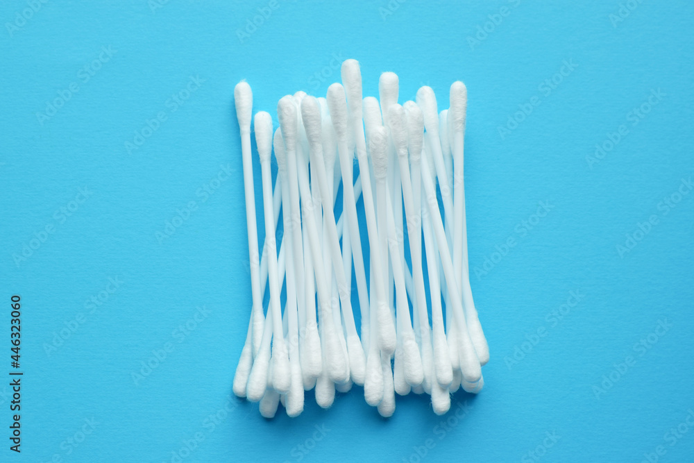 Lots of plastic cotton swabs on a blue background. Lots of plastic cotton swabs on a blue background.