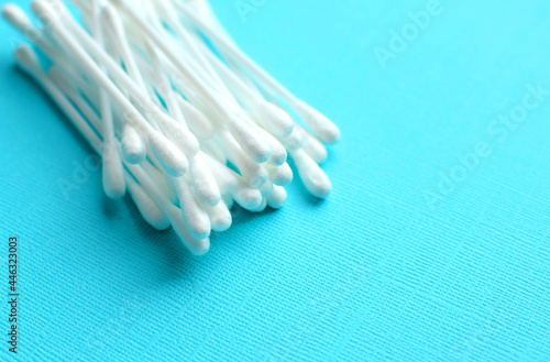 Lots of plastic cotton swabs on a blue background. photo