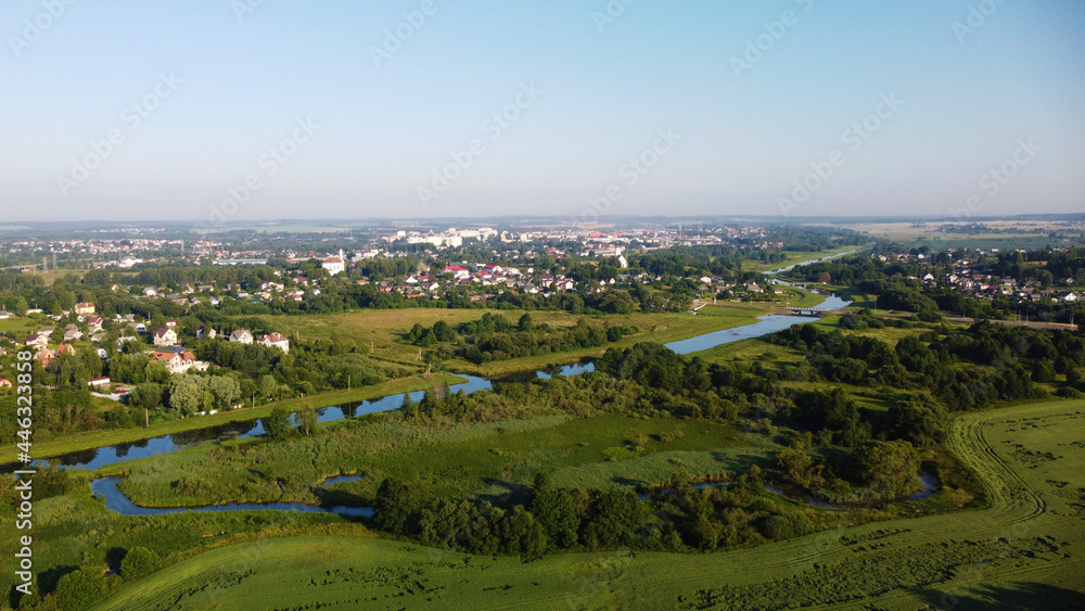 Aerial view of the blue river and green meadows