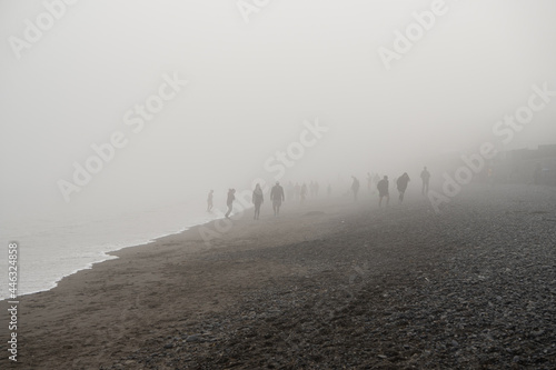 Fotografija Shadowy figures in the fog on the beach