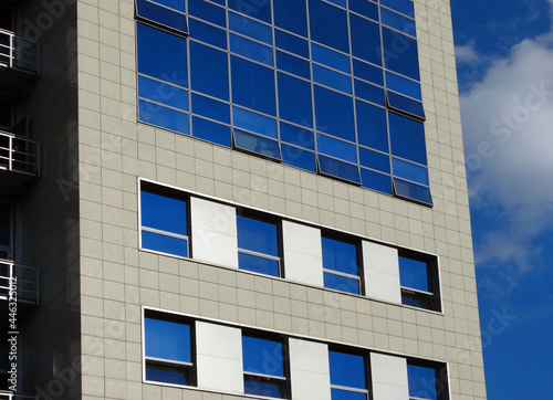 A fragment of a modern building with many windows.