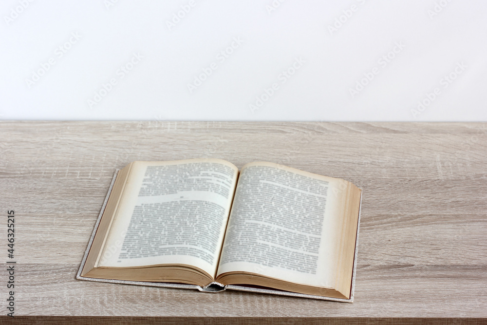 Obraz premium an open book with blurry text on a table