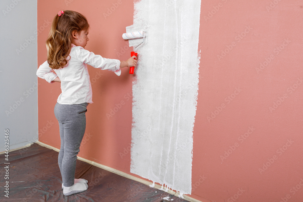 father and daughter paint the wall in the room. home renovation father and daughter paint the wall in the room. home renovation