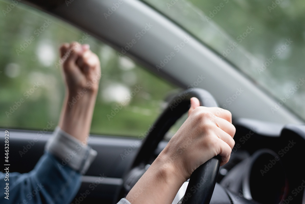 Angry driver shakes her fist in the traffic jam. Angry driver shakes her fist in the traffic jam.