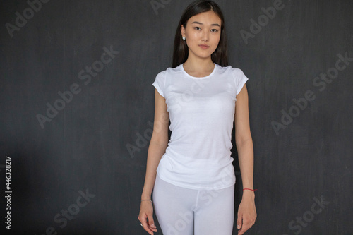 Attractive asian girl in white t-shirt and leggings. Mock-up.