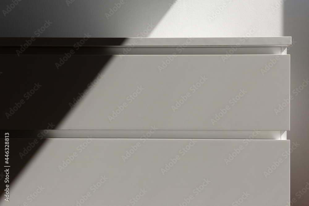 minimalistic white furniture chest of drawers without handles in the sunlight minimalistic white furniture chest of drawers without handles in the sunlight