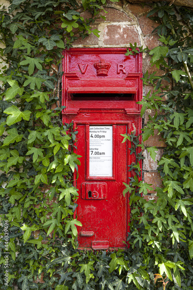 An ivy clad pre 1901 Victorian post box (VR Victoria Regina) in the Exmoor village of Bury, Somerset UK An ivy clad pre 1901 Victorian post box (VR Victoria Regina) in the Exmoor village of Bury, Somerset UK