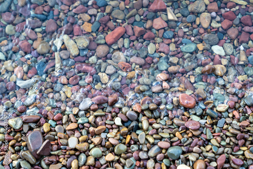 Brightly colored rocks and pebbles on the shores of Lake McDonald in Glacier National Park, in selective focus photo