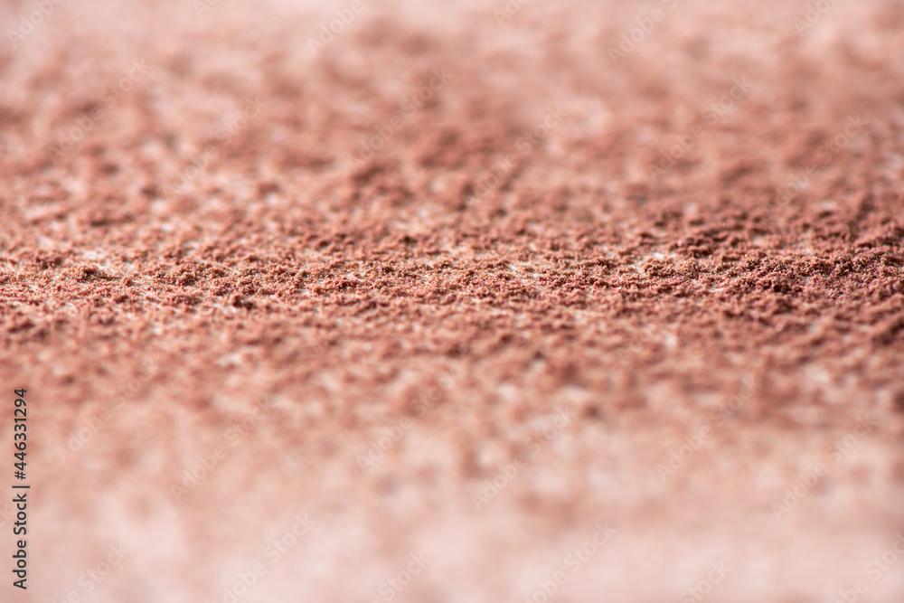 Loosed dry cosmetic pink background pigment. Top view of cracked blush, bronzer, powder or eye shadow cosmetic products. White background, selective focus Loosed dry cosmetic pink background pigment. Top view of cracked blush, bronzer, powder or eye shadow cosmetic products. White background, selective focus
