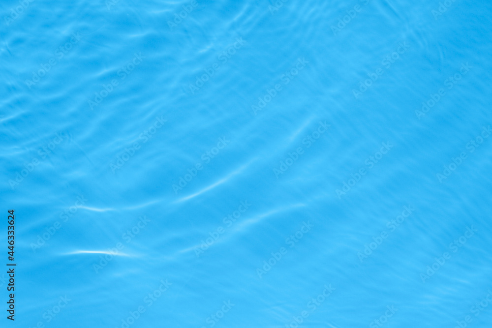 The surface of light on blue transparent swimming pool water. Trendy abstract wavy background. Water waves in sunlight. Banner with copy space The surface of light on blue transparent swimming pool water. Trendy abstract wavy background. Water waves in sunlight. Banner with copy space