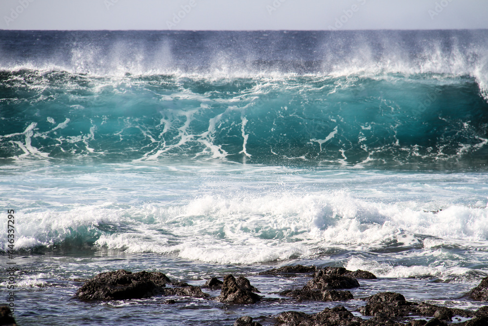 Fototapeta premium sea landscape, blue sea waves crashing against the rocks, big turquoise wave in the ocean