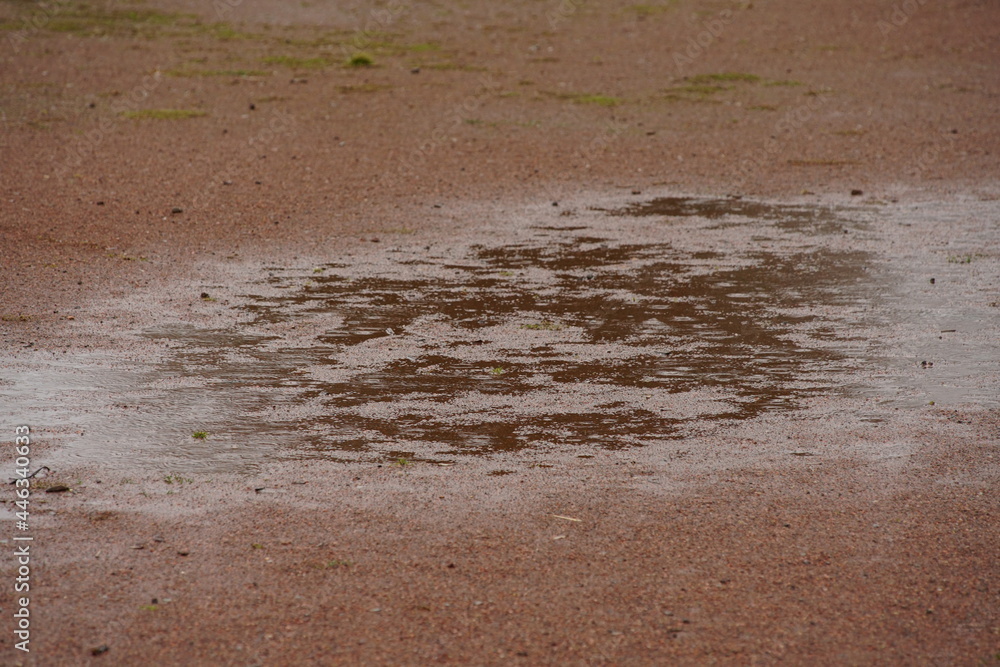 Wet terrain after a long rain on the ground with pavement Wet terrain after a long rain on the ground with pavement