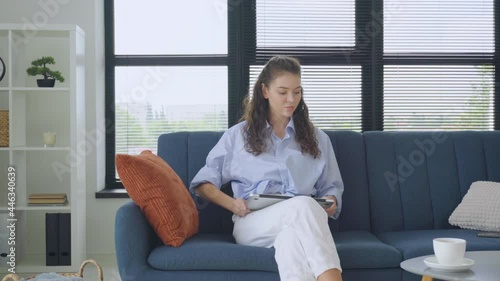 Business freelance woman stretching her body because feel tired after working on a laptop in a living room. Lifestyle women relax after working at home concept.