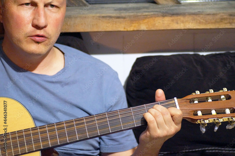 Obraz premium A 45-year-old man plays the guitar