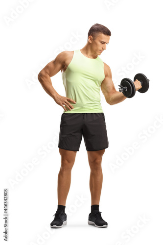 Full length portrait of a bodybuilder in sportswear exercising with a dumbbell