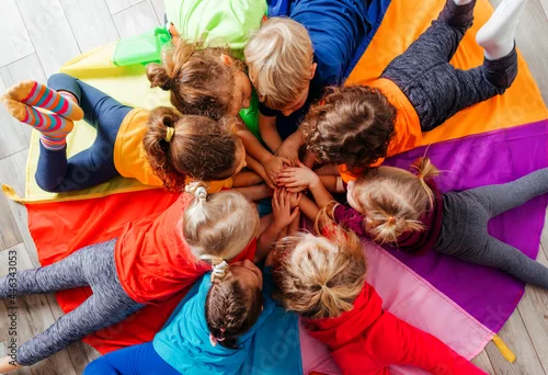 Obraz Cheerful children playing team building games on a floor