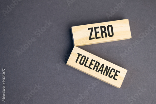 Zero Tolerance words on wooden blocks on yellow background. Business ethics concept.
