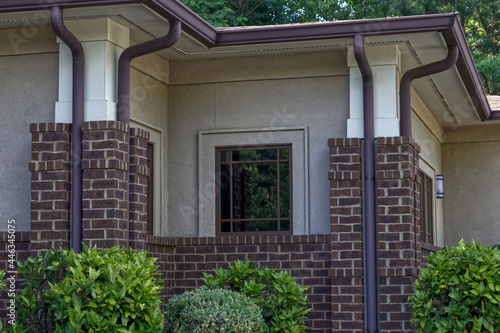 Close up vintage style brick facade brown gutters