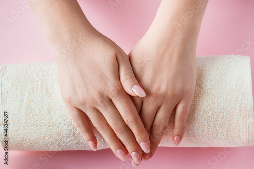 Spa procedure for nail care in a beauty salon. Female hands and tools for manicure on pink background. Bodycare concept.