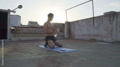 A man doing calisthenics exercises on the terrace at home