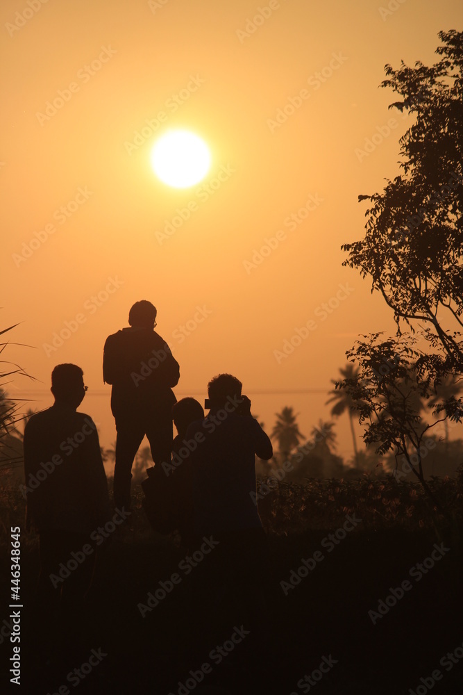 silhouette image of man taking photograph of the sunrise. silhouette picture of man in the outdoor