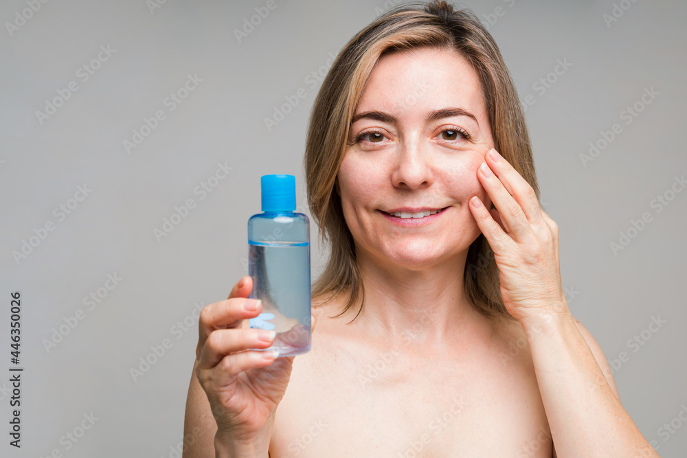 Portrait of an older woman cleaning her face Portrait of an older woman cleaning her face