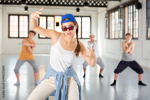 Team of young dancers training street dance moves and having fun photo