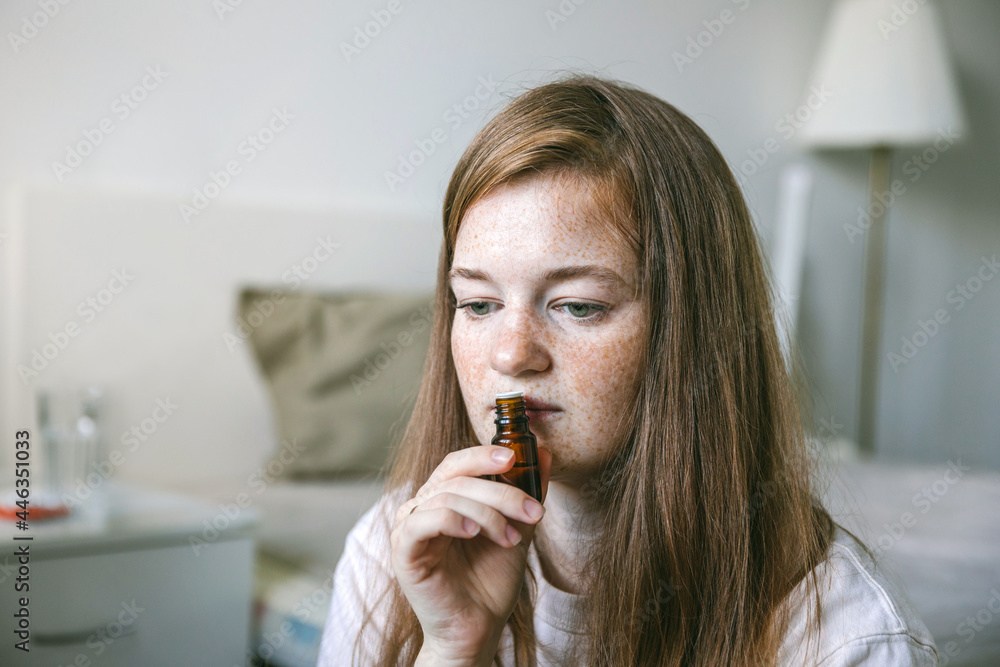 Young woman is sniffing essential oil. Loss of smell and taste from Covid Young woman is sniffing essential oil. Loss of smell and taste from Covid