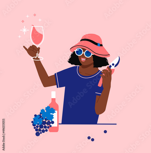 Obraz na plátně winegrower woman holding glass of wine and a pruner near wine bottle and grapes