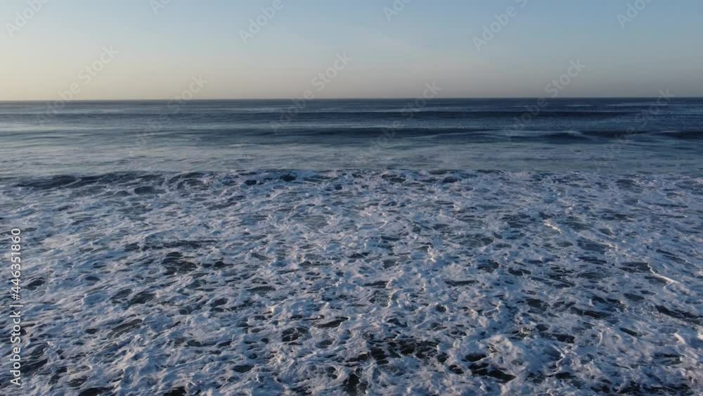 sea waves recorded from the front with drone, gradient of sky and ocean in blue tones sea waves recorded from the front with drone, gradient of sky and ocean in blue tones