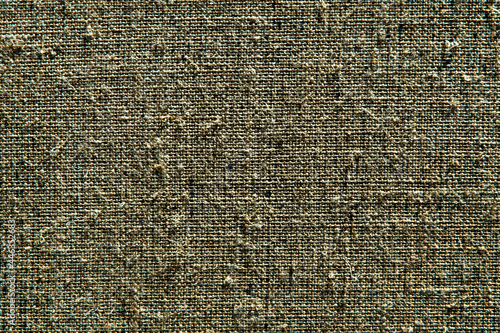 dark creative background: reverse side of black-primed linen canvas, uneven lighting, color toning