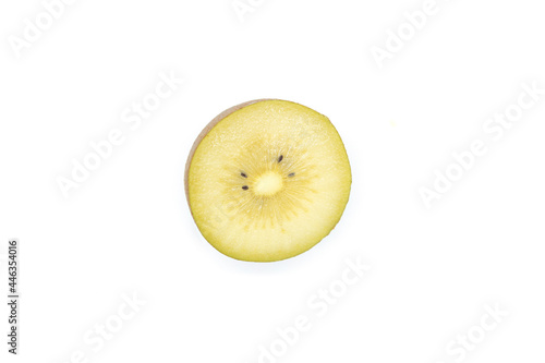 Kiwi fruit cut in half, showing the flesh in the upper corner, isolated on a white background.