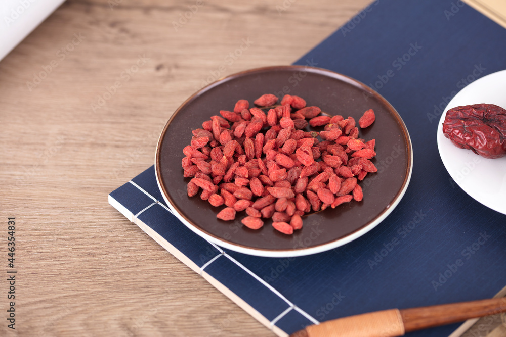 A plate of red medlar is on the medical book A plate of red medlar is on the medical book