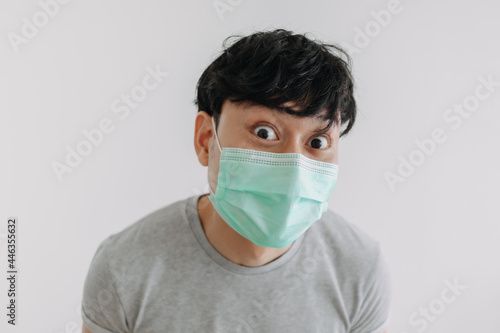 Close up of Happy Asian man wears mask isolated on white background.